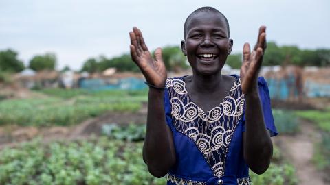 A woman with her hands up.