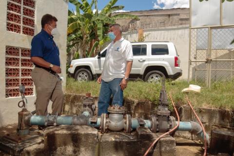 men standing at water source
