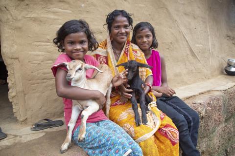 women holding goats