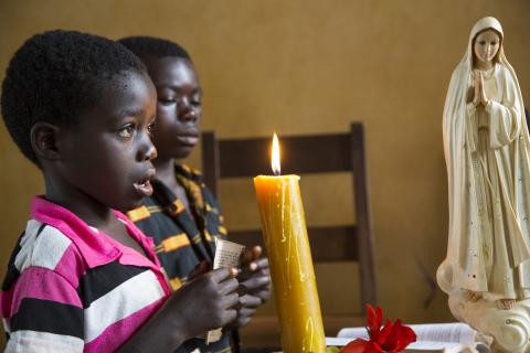boys lighting a candle