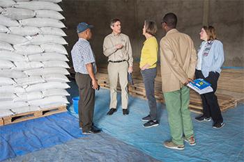 People standing by supplies.