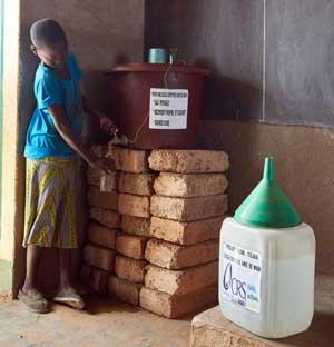 A girl filling up a plastic bottle.