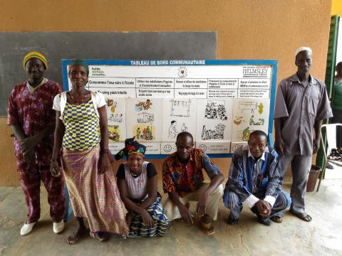 A group of people posing in front of a school board.