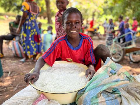 Boy holding a bowl of rice