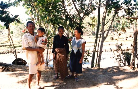 Man holding baby and two women