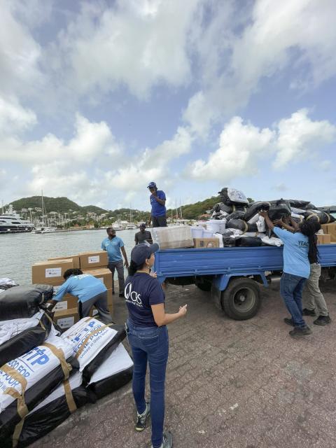 People loading up supplies onto a truck