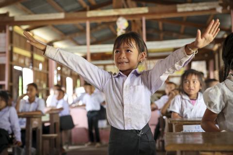 Girl standing with upraised arms