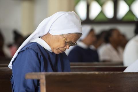 Nun bowing in prayer