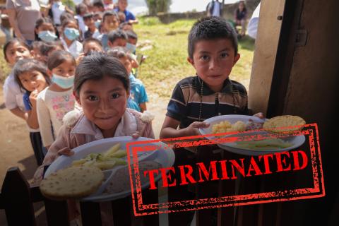 Terminated stamp over children holding out plates of food