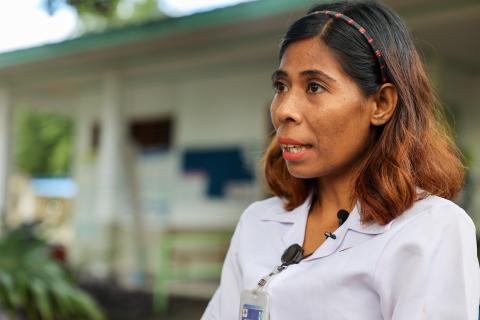 A woman dressed in white talking.