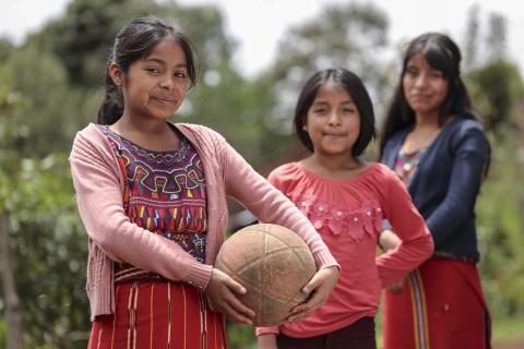 three young girls playing ball