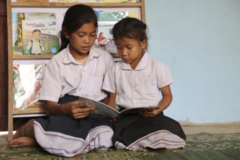 two young girls reading
