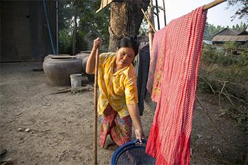 Household chores are difficult for Neoum, who lives with a physical disability that makes walking a challenge. Still, she welcomed her brother-in-law into her home, even though it increased her workload.