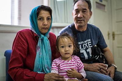 Sabriya and Ghullamali, with daughter Hasti, seek rest and refuge at the Caritas Athens Refugee Center on their way to Germany. Their two older children, both teens, traveled to Germany unaccompanied almost a year ago. The center is helping the family reu