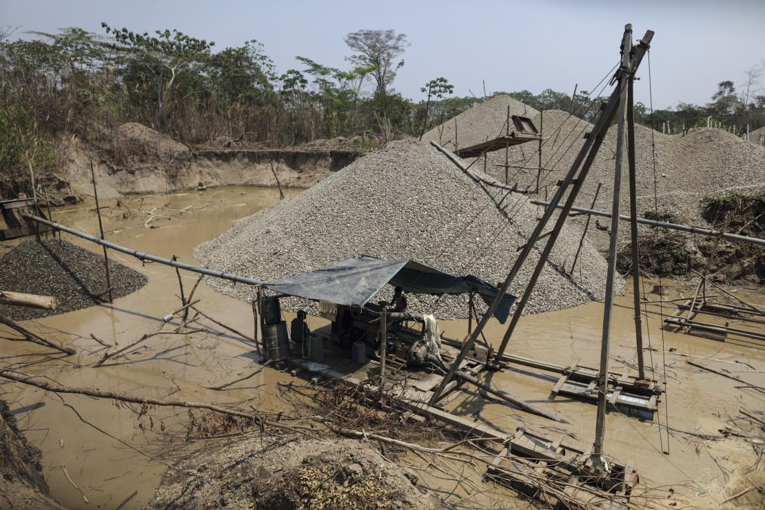 This is a mining rig in the Peruvian Amazon. The hills are what are left behind after the mining process. Photo by Oscar Leiva/CRS