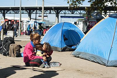 A moment of tenderness captured at park near a bus station in Belgrade. Photo by Kira Horvath for CRS