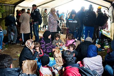 Refugees wait in one of 20 tents sheltering refugees at Vasariste. Doctors and translators are working with CRS and Caritas to provide basic medical services and information about the border crossing. Photo by Kira Horvath for CRS