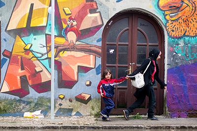 Refugees hurry to the Mixer House distribution center near the Belgrade bus station. CRS and Caritas are distributing hygiene kits, food and other basic items to the thousands of refugees passing through Belgrade daily. Photo by Kira Horvath for CRS