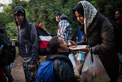 In Europe, CRS and our partners are preparing refugees for a long, cold winter with essentials like warm clothing, sleeping bags and mats, food rations and clean water. Photo by Andrew McConnell for CRS