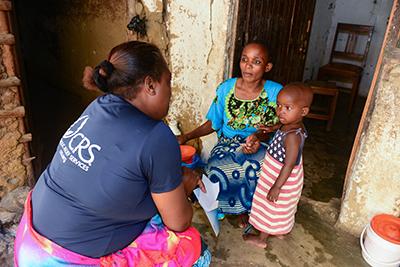 Community-based volunteers provided regular home visits to more than 17,000 households—a total of 177,706 home visits in year 3. Photo by Philip Laubner/CRS 
