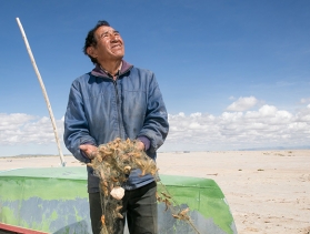 Bolivian man stands in middle of dry lakebed