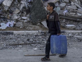 conflict scene in mid east with boy carrying jerry can