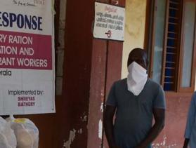 people stand in line during covid response in India