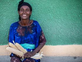 Ethiopian woman poses for the camera with ears of corn 