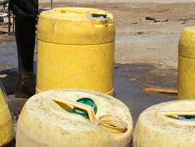 filling water jugs in drought-stricken Kenya