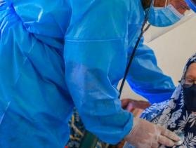 Hospital worker helping patient