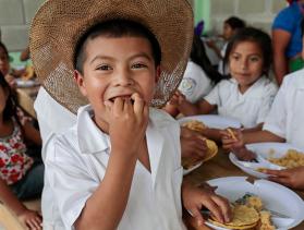 Little boy from Honduras eating food