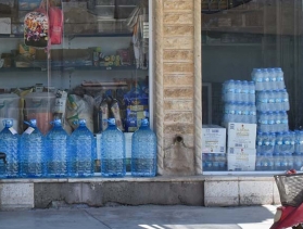 Iraq shopkeeper outside his store