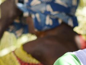 Kenya woman at onion harvest participates in savings group