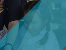 Two school children hugging each other.