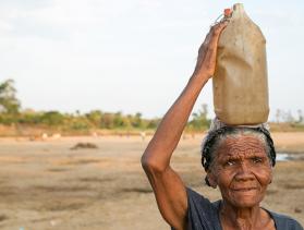 Woman from Madagascar carries a jug of water on her head