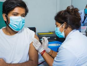 Man from Nepal gets a COVID-19 vaccine shot 