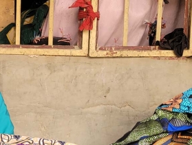 smiling woman at sewing machine in Nigeria