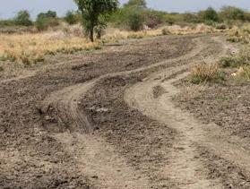 two South Sudanese people walk down a road