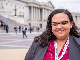 Woman poses in front of U.S. Capitol
