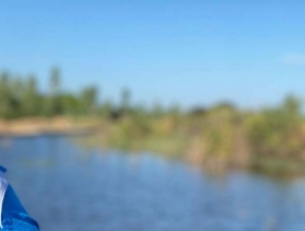 woman smiling near reservoir in Zimbabwe