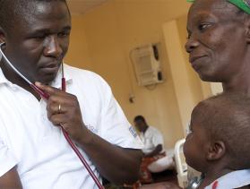Photo by Jake Lyle for CRS After her daughter died from AIDS-related illness, Mrs. Regina Mwape (right) was left to care for her grandson Josphat Kachingala.
