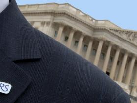 Man standing in front of Capitol building wearing suit