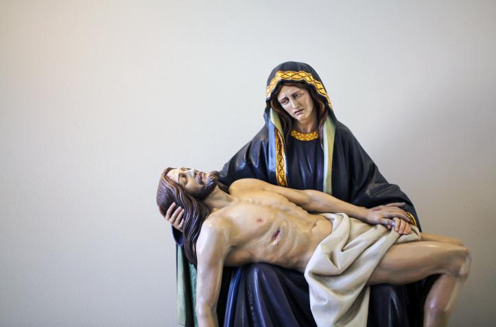 "Sculpture of Mary holding Jesus after the crucifixion, expressing sorrow and compassion.