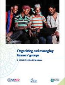 Cover of "Organizing and Managing Farmers’ Groups: A SMART Skills Manual." Features four farmers smiling at a laptop. Logos of USAID, CRS, and IFAD are at the bottom.