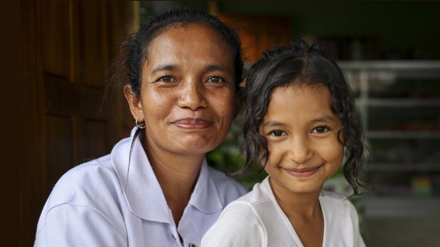 A woman and a child smiling.