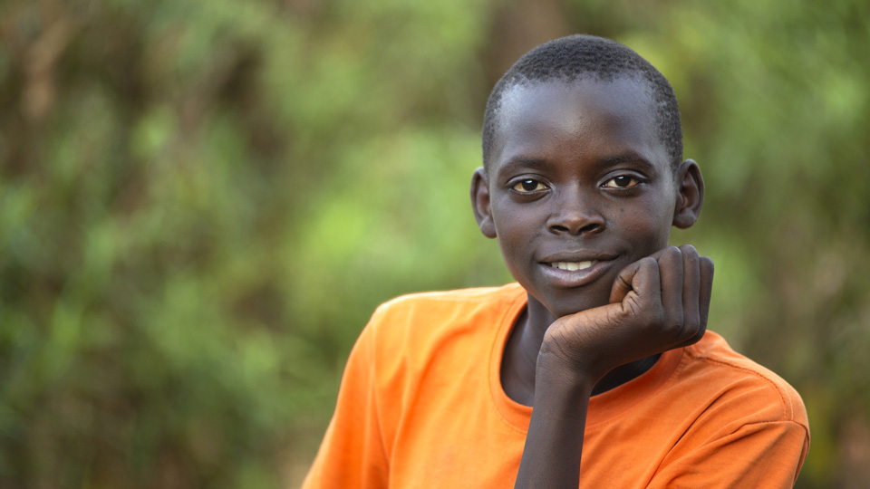A boy in orange shirt.