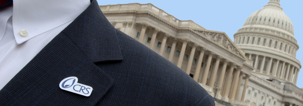 Man standing in front of Capitol building wearing suit