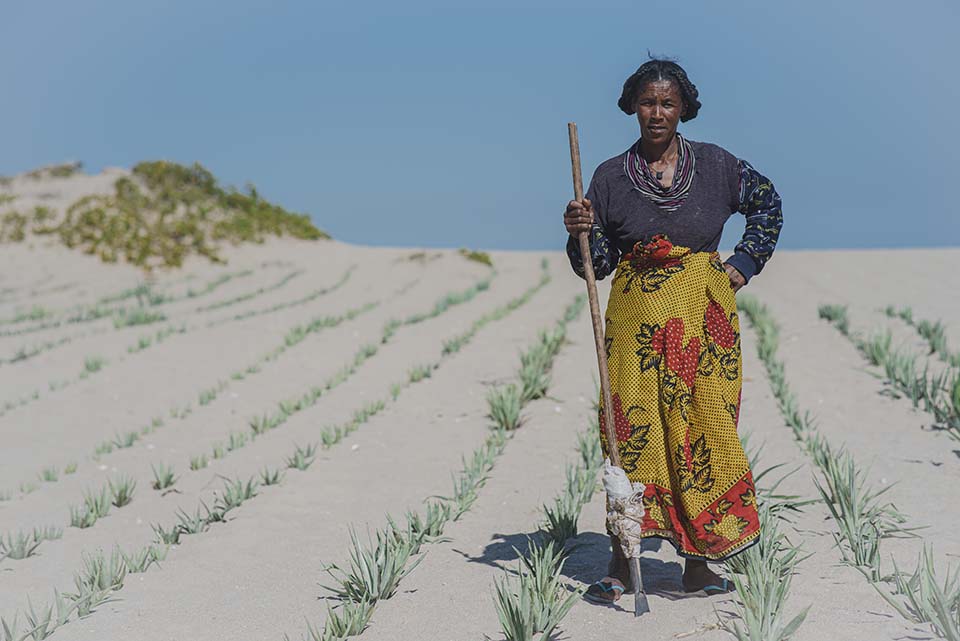 woman stands on sand dunes in Madagascar